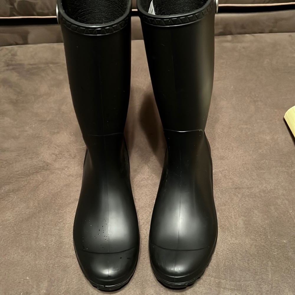 These are Ugg waterproof boots that are below knee, black, size 9.